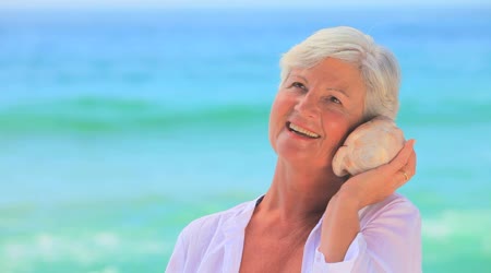 depositphotos_23499763-Elderly-woman-listening-to-a-shell